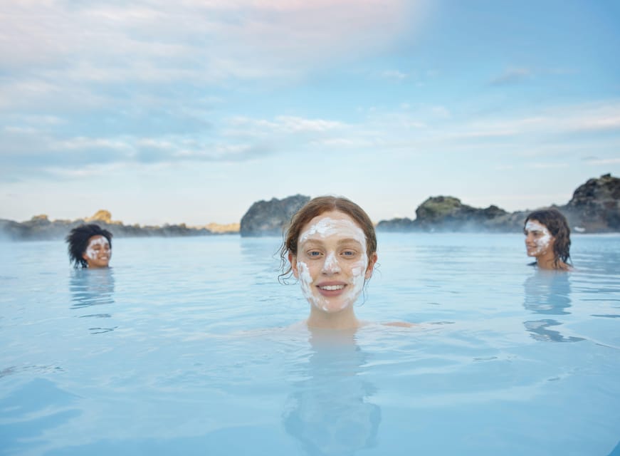 Blue Lagoon: Admission Package with Drink, Towel, and Mask - Entering the milky-blue geothermal water